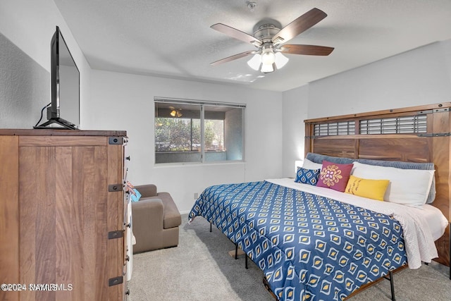 bedroom with light carpet, a textured ceiling, and ceiling fan