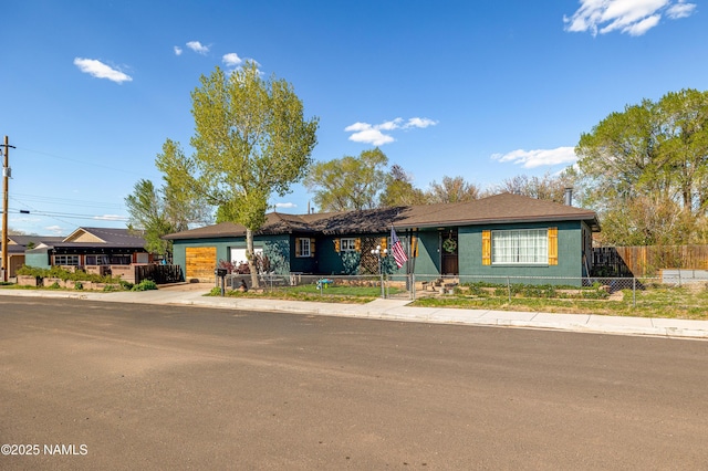 502 N Humbolt St, Williams, AZ 86046 - ranch-style home with an attached garage, a fenced front yard, and concrete driveway