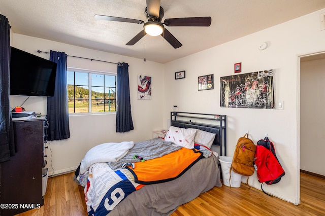 502 N Humbolt St, Williams, AZ 86046 - bedroom with wood finished floors, baseboards, and a ceiling fan
