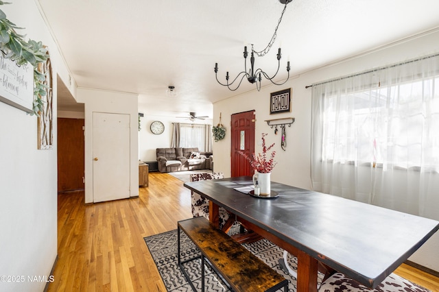 502 N Humbolt St, Williams, AZ 86046 - dining space with light wood finished floors, a chandelier, and ceiling fan