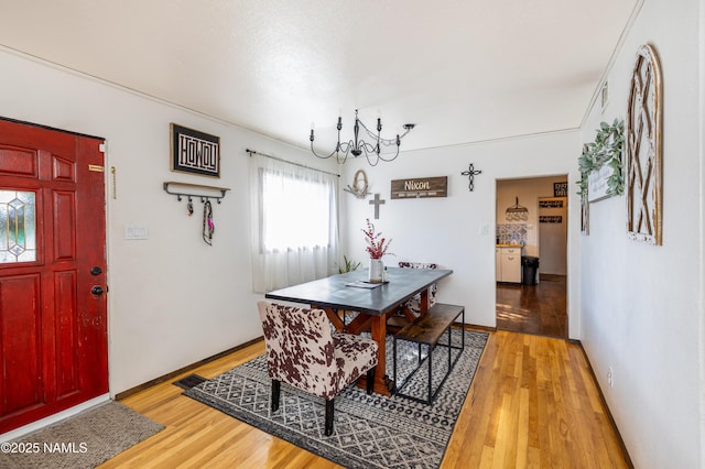 502 N Humbolt St, Williams, AZ 86046 - dining area featuring light wood-style flooring, a chandelier, and baseboards