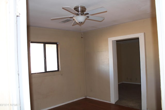 unfurnished room with ceiling fan and dark hardwood / wood-style floors