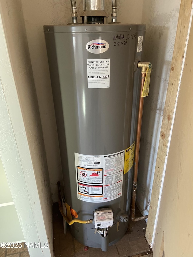 utility room featuring water heater