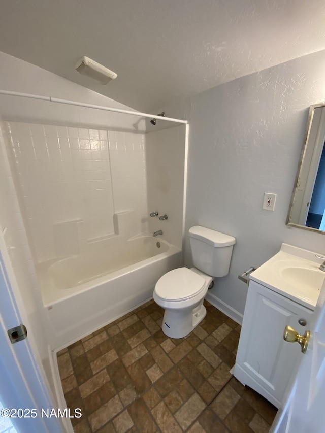 full bathroom featuring toilet, bathing tub / shower combination, baseboards, and vanity