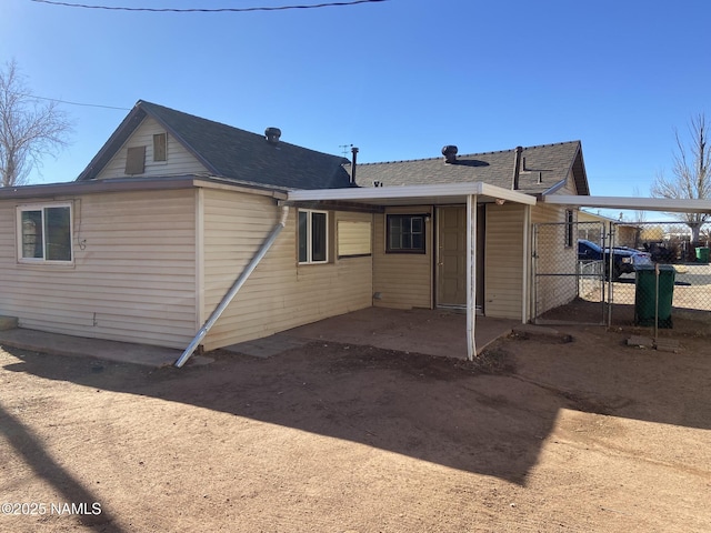 back of house featuring fence