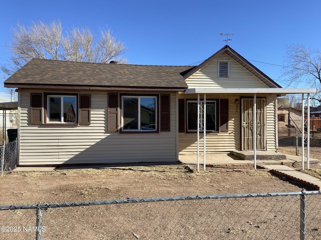 view of front of home with a shingled roof and fence private yard