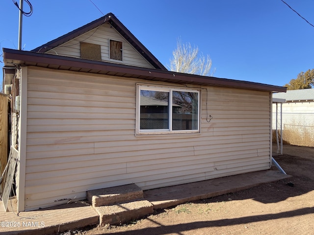 view of side of property featuring fence