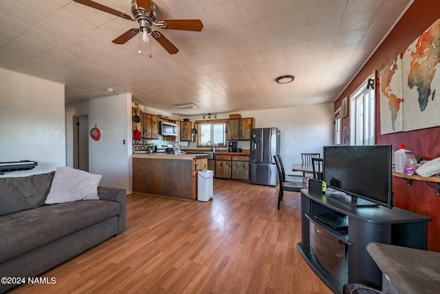 living room featuring ceiling fan and light wood-type flooring