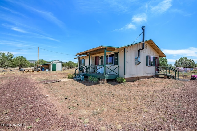 view of front of property with a storage shed