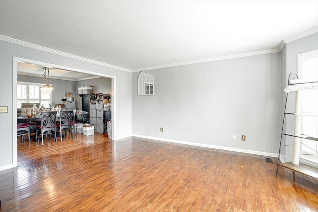 living room featuring hardwood / wood-style floors, a chandelier, and ornamental molding