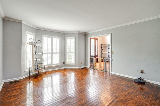 empty room with crown molding and wood-type flooring