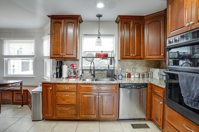 kitchen with black double oven, light tile patterned floors, sink, and stainless steel dishwasher