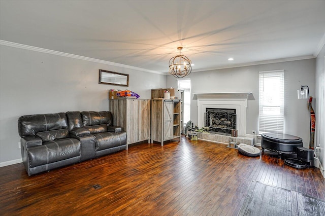 living room with ornamental molding, a chandelier, and dark hardwood / wood-style flooring