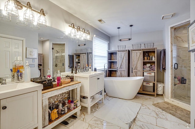 bathroom with vanity and shower with separate bathtub