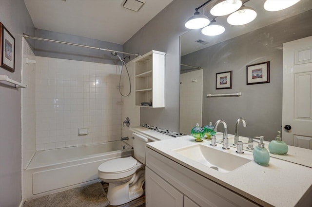 full bathroom featuring tiled shower / bath, vanity, and toilet