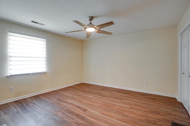 interior space featuring light wood-type flooring, ceiling fan, and a textured ceiling