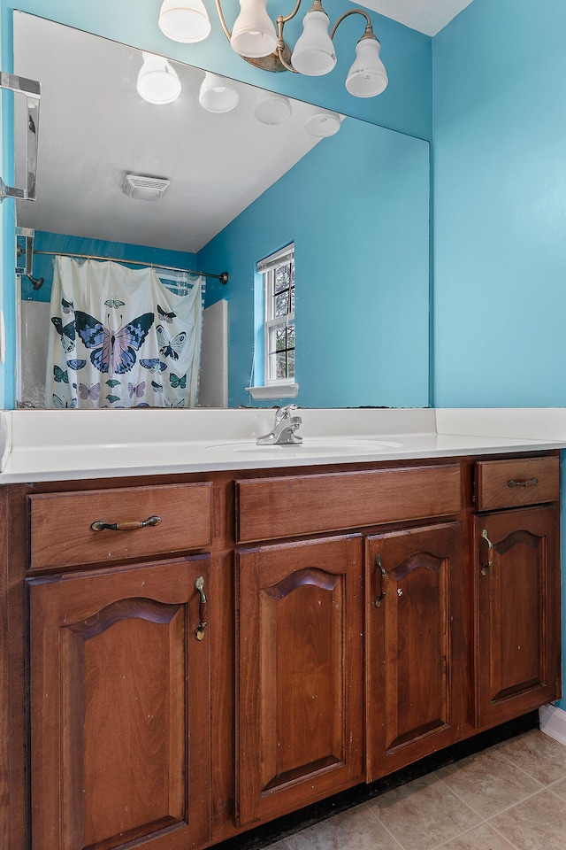 bathroom with vanity, a shower with shower curtain, and tile patterned flooring