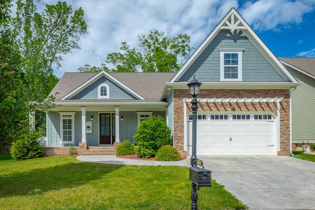 craftsman house featuring a front lawn, a garage, and a porch