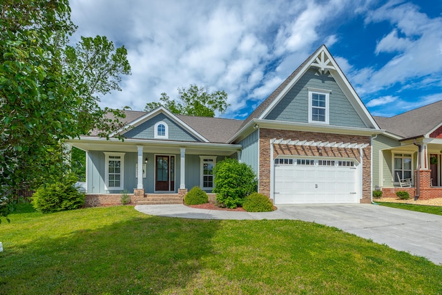 craftsman-style house featuring a garage, a front yard, and a porch