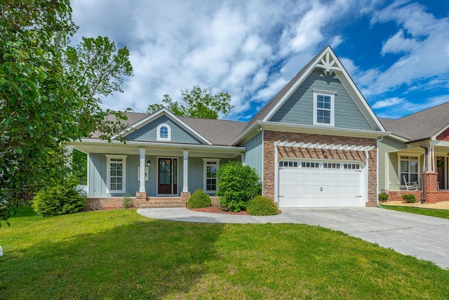 8337 Glenshire Ln, Chattanooga, TN 37421 - view of front of house with driveway, a front yard, covered porch, roof with shingles, and a garage
