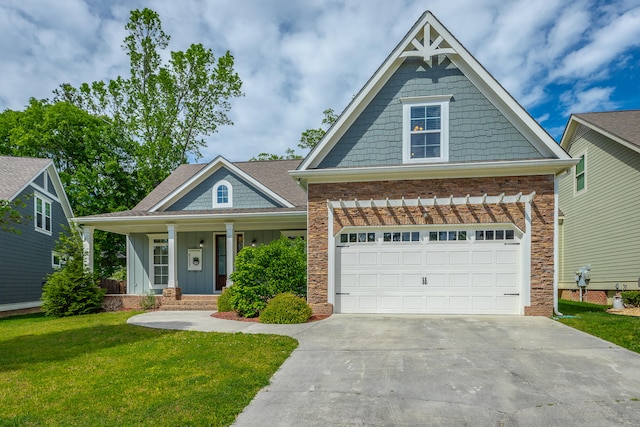 craftsman-style house featuring a garage, a porch, and a front yard