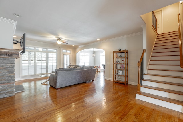 living room featuring ceiling fan, ornamental molding, and hardwood / wood-style flooring