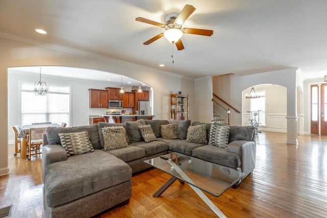8337 Glenshire Ln, Chattanooga, TN 37421 - living area with arched walkways, ceiling fan with notable chandelier, a healthy amount of sunlight, and light wood finished floors