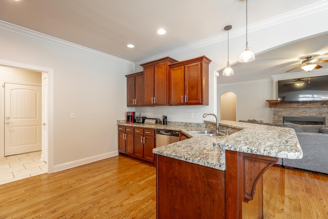 kitchen featuring decorative light fixtures, a fireplace, light hardwood / wood-style floors, kitchen peninsula, and ceiling fan