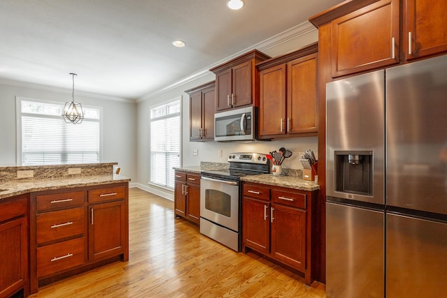 8337 Glenshire Ln, Chattanooga, TN 37421 - kitchen with crown molding, stainless steel appliances, light stone counters, pendant lighting, and light wood finished floors