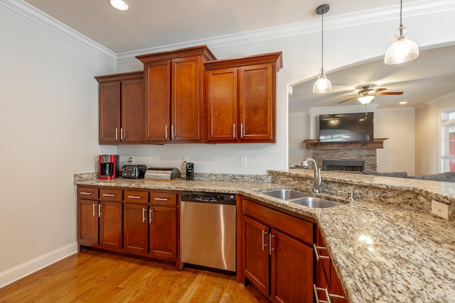 kitchen featuring light wood-type flooring, a fireplace, dishwasher, sink, and ceiling fan