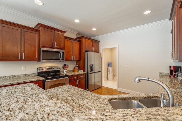 kitchen with light hardwood / wood-style flooring, crown molding, stainless steel appliances, sink, and light stone counters