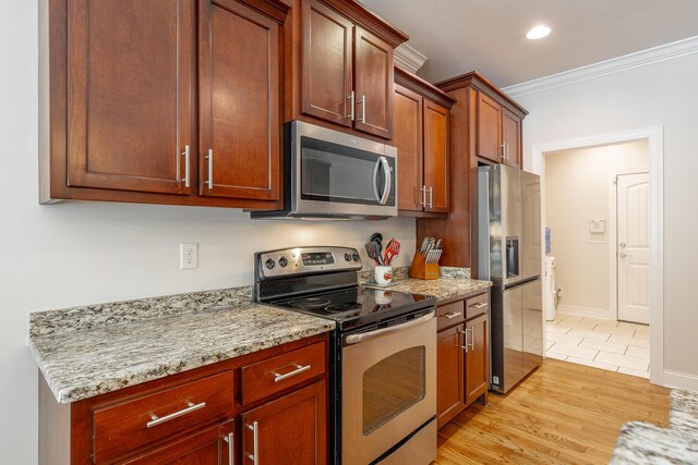 8337 Glenshire Ln, Chattanooga, TN 37421 - kitchen with light wood-style flooring, ornamental molding, appliances with stainless steel finishes, and light stone counters