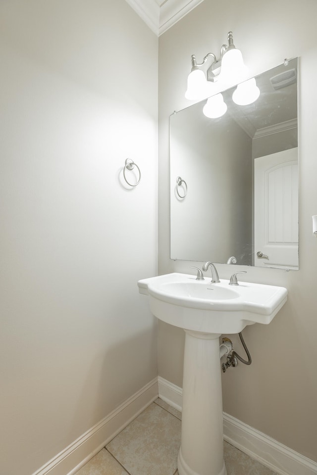 bathroom featuring tile patterned flooring, sink, and ornamental molding