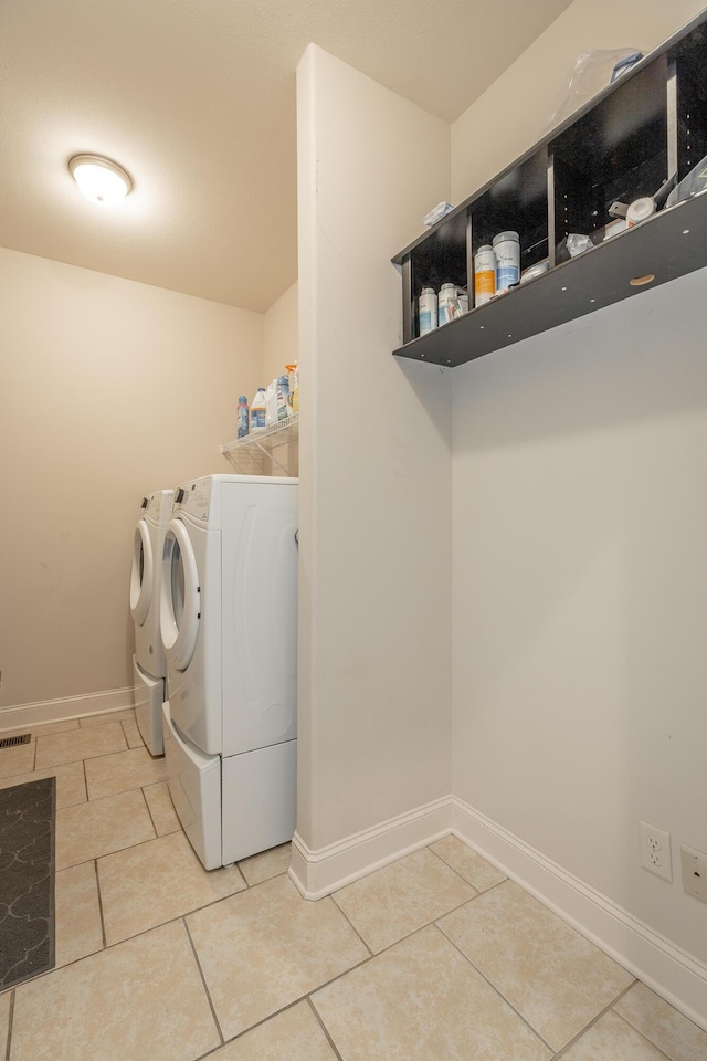 8337 Glenshire Ln, Chattanooga, TN 37421 - clothes washing area featuring baseboards, laundry area, tile patterned flooring, and washer and dryer