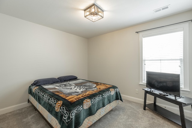 bedroom featuring carpet floors and multiple windows