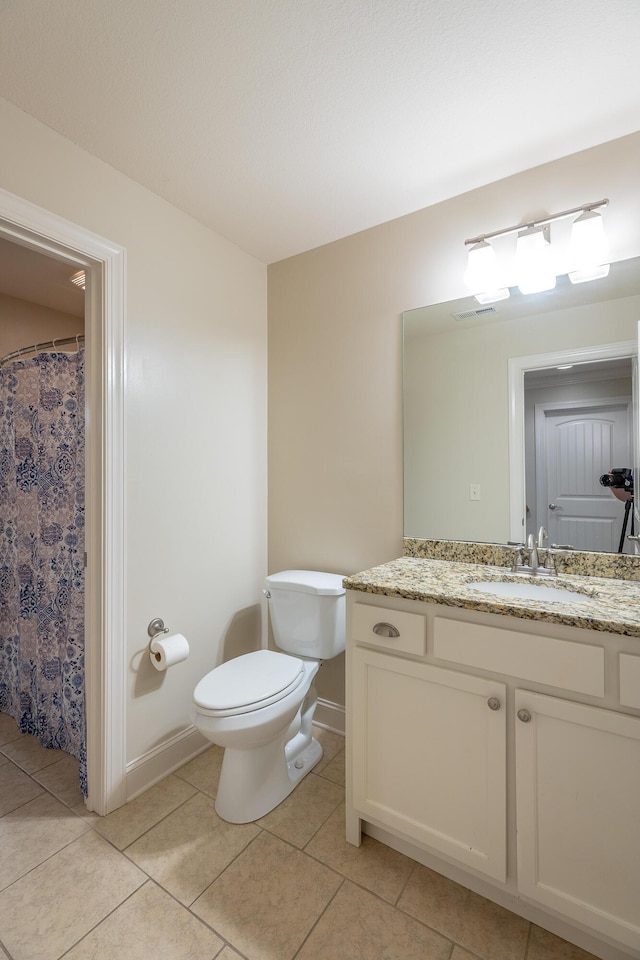 8337 Glenshire Ln, Chattanooga, TN 37421 - bathroom featuring toilet, vanity, tile patterned floors, and baseboards