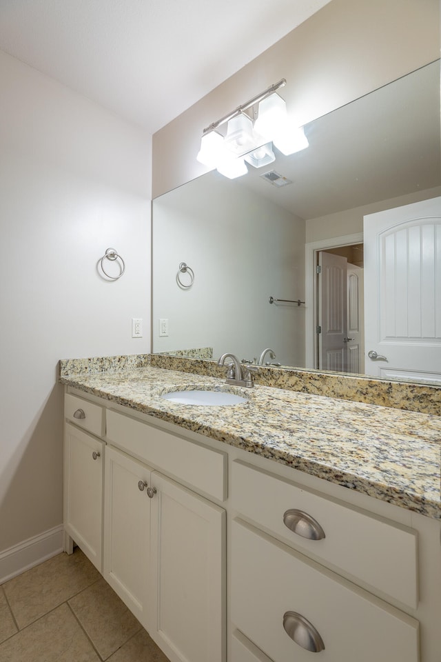 bathroom with tile patterned flooring and vanity