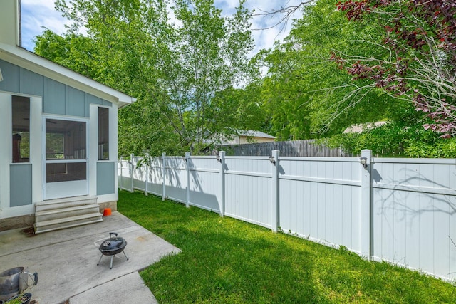 8337 Glenshire Ln, Chattanooga, TN 37421 - view of yard with a fenced backyard, a fire pit, entry steps, and a sunroom