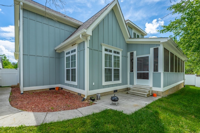 exterior space with a sunroom and a yard