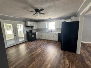 kitchen featuring french doors, white cabinetry, black appliances, dark wood-type flooring, and ceiling fan