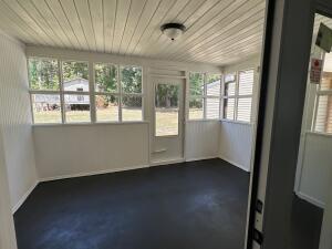 unfurnished sunroom featuring wooden ceiling and a wealth of natural light