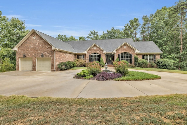 ranch-style home with a garage and a front lawn