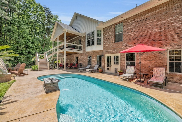 view of pool featuring french doors and a patio area