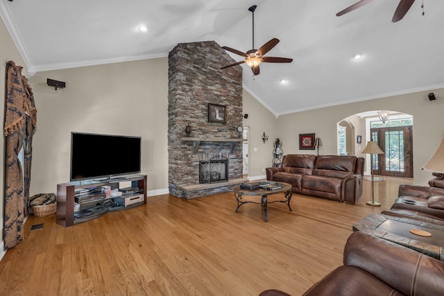 living room with a fireplace, crown molding, light hardwood / wood-style flooring, and ceiling fan