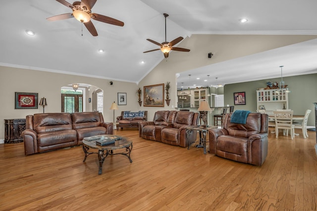 living room with crown molding, ceiling fan, high vaulted ceiling, and light wood-type flooring