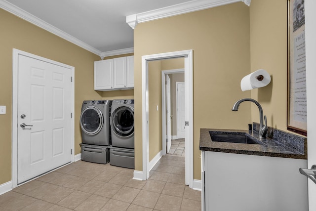 laundry area with crown molding, sink, light tile patterned flooring, cabinets, and washing machine and dryer