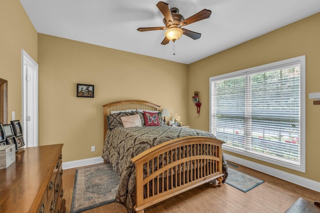 bedroom with wood-type flooring and ceiling fan