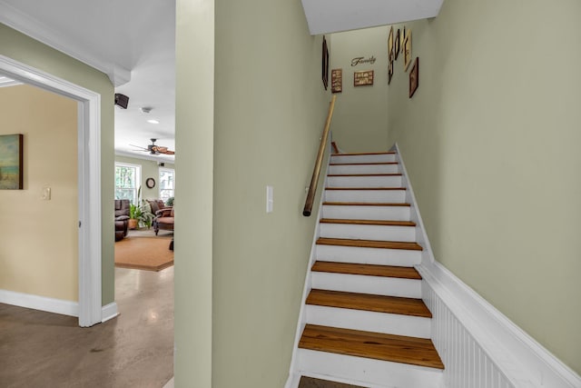 stairs with concrete floors and ceiling fan