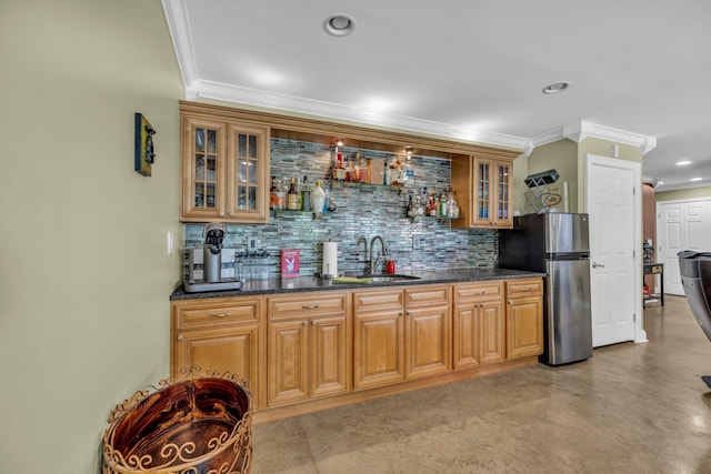 bar with ornamental molding, stainless steel fridge, backsplash, and sink