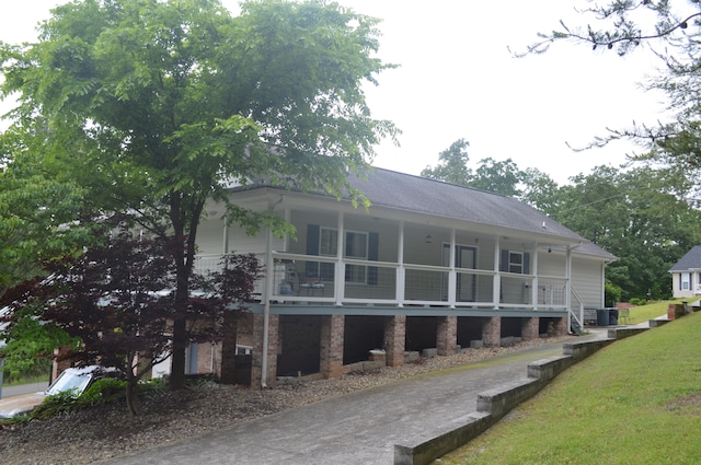 exterior space featuring a balcony and a lawn